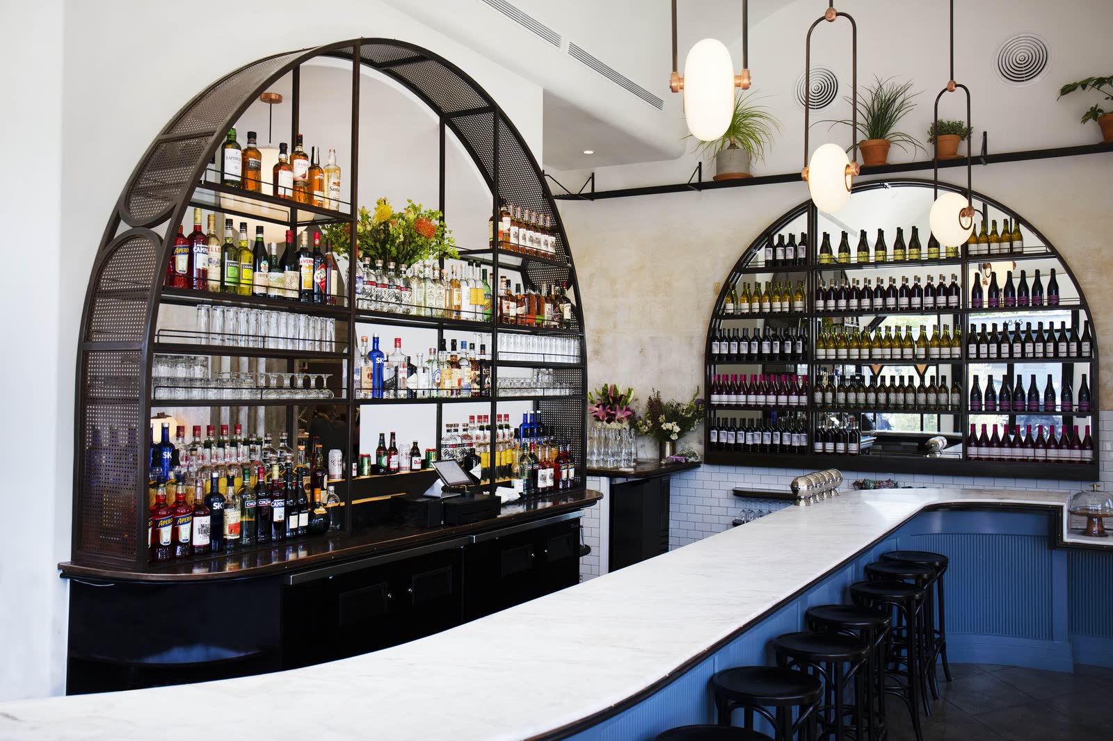 Five Leaves: arched bottle shelves above the bar, and a plaster archway
