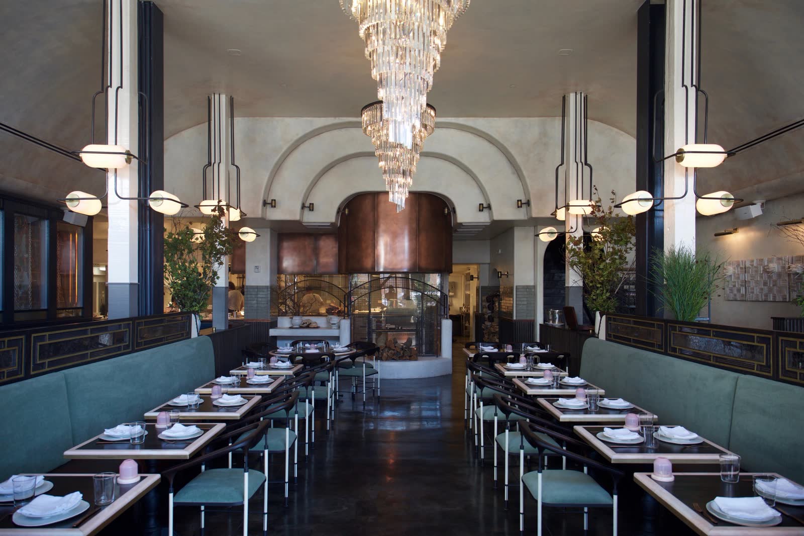 Gwen: the dining hall with green banquettes, and an arched doorway