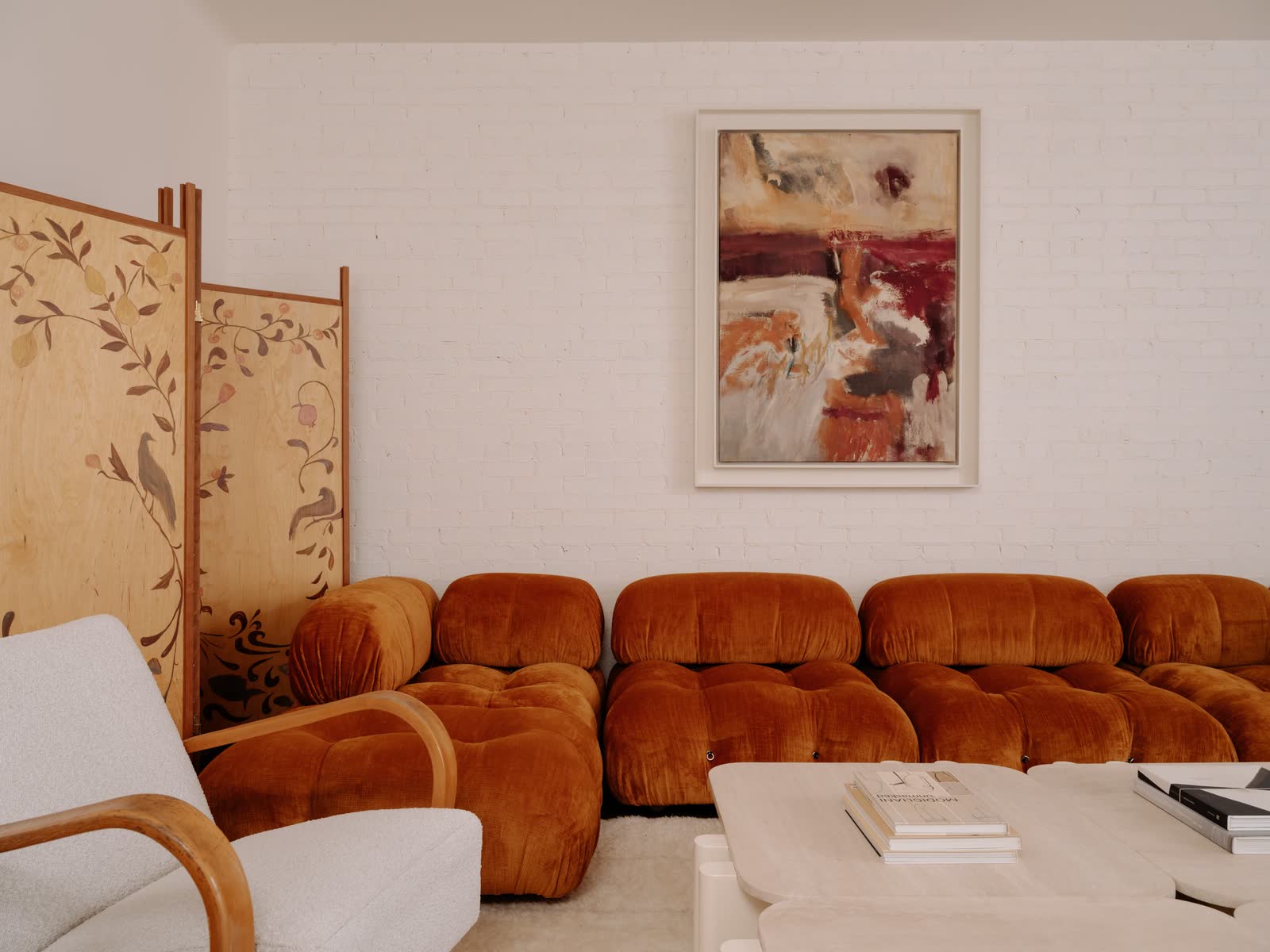 Williamsburg Townhouse: the living room, and arched doors beneath a timber stair